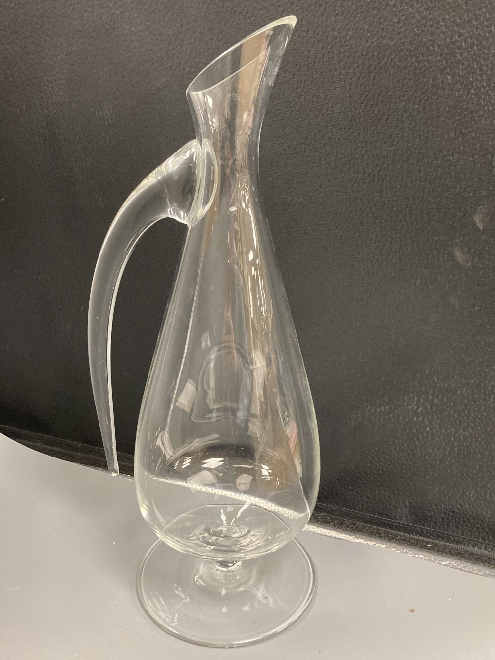 A contemporary Reidel glass jug, signed, height 39cm